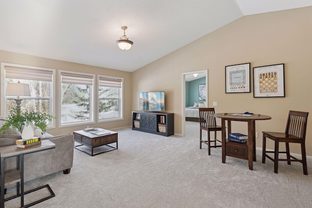 carpeted living room featuring lofted ceiling