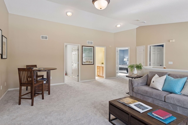 carpeted living room with lofted ceiling