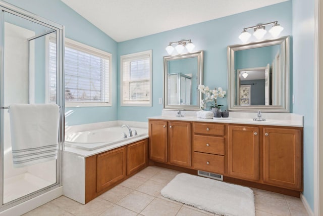 bathroom featuring vanity, tile patterned flooring, and plus walk in shower