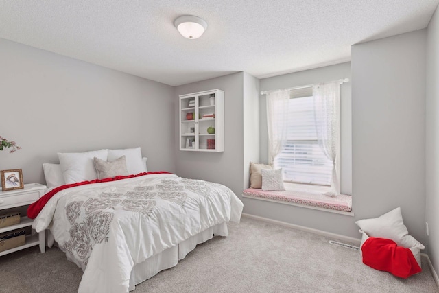 bedroom featuring carpet and a textured ceiling