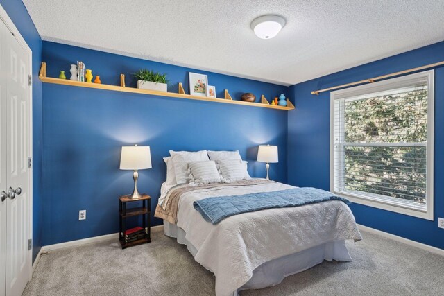 bedroom with carpet flooring and a textured ceiling