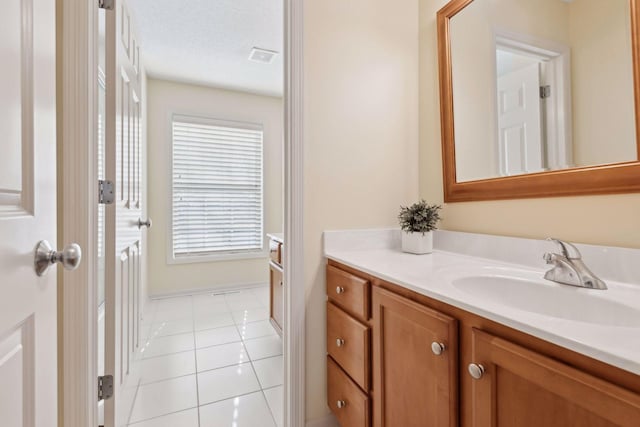 bathroom with vanity, tile patterned floors, and a textured ceiling