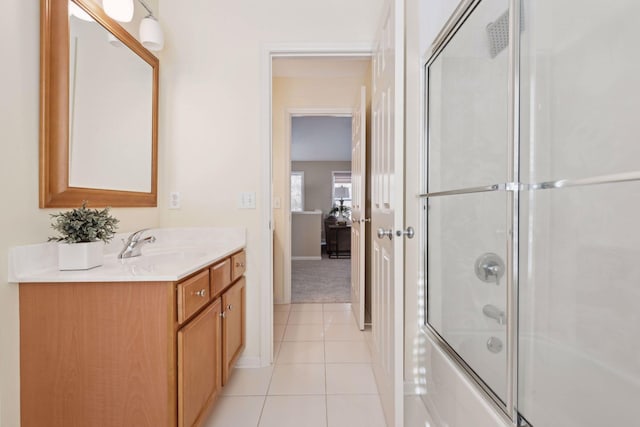 bathroom featuring vanity, combined bath / shower with glass door, and tile patterned floors