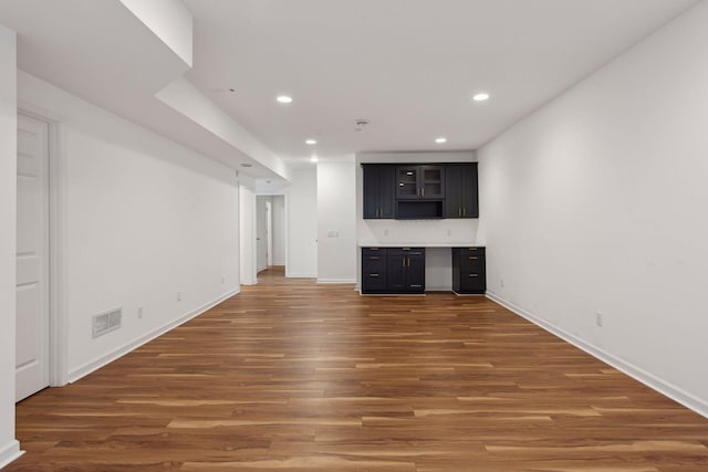 unfurnished living room with dark hardwood / wood-style flooring