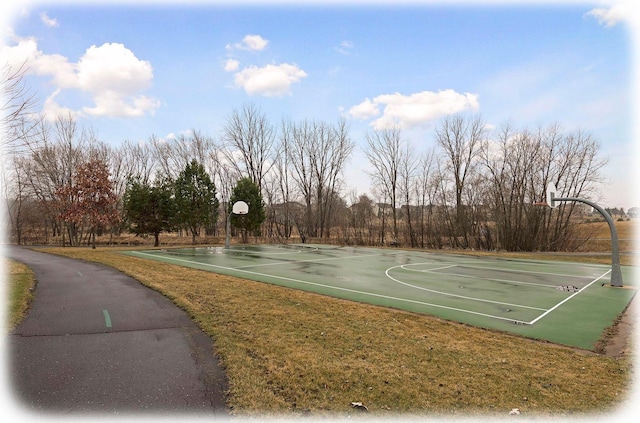 view of sport court featuring a yard