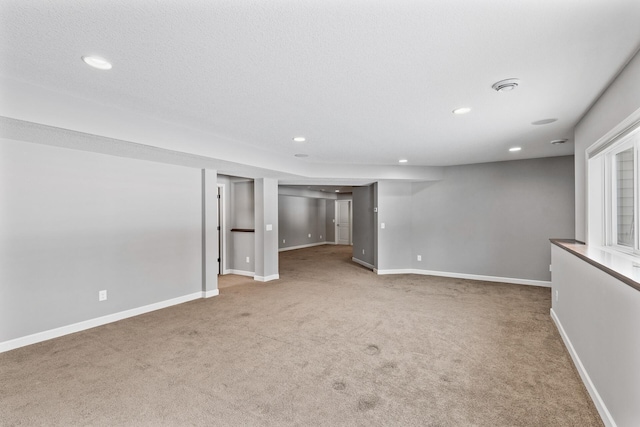 unfurnished room with carpet floors and a textured ceiling