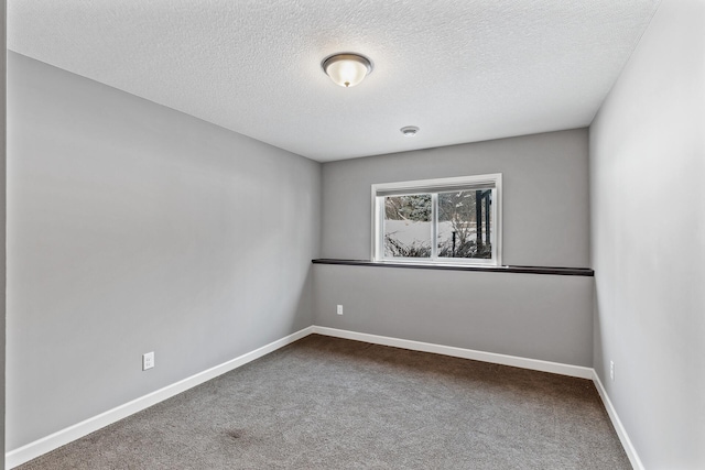 carpeted empty room with a textured ceiling