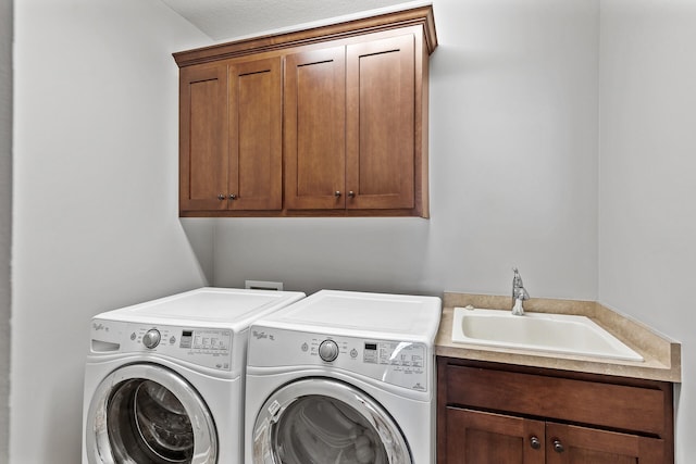 laundry area with cabinets, sink, and independent washer and dryer