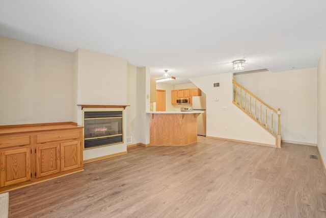 unfurnished living room featuring light hardwood / wood-style flooring