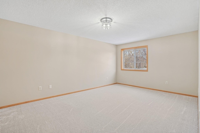 carpeted spare room featuring a textured ceiling