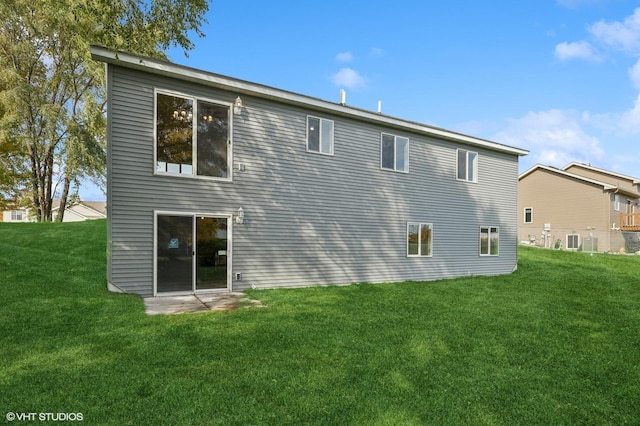 rear view of house with a yard