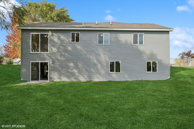 rear view of property with a lawn