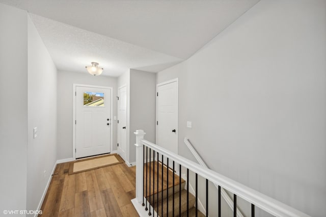 entrance foyer featuring wood-type flooring and a textured ceiling