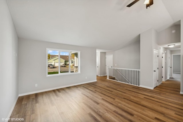 spare room featuring lofted ceiling, hardwood / wood-style floors, and ceiling fan