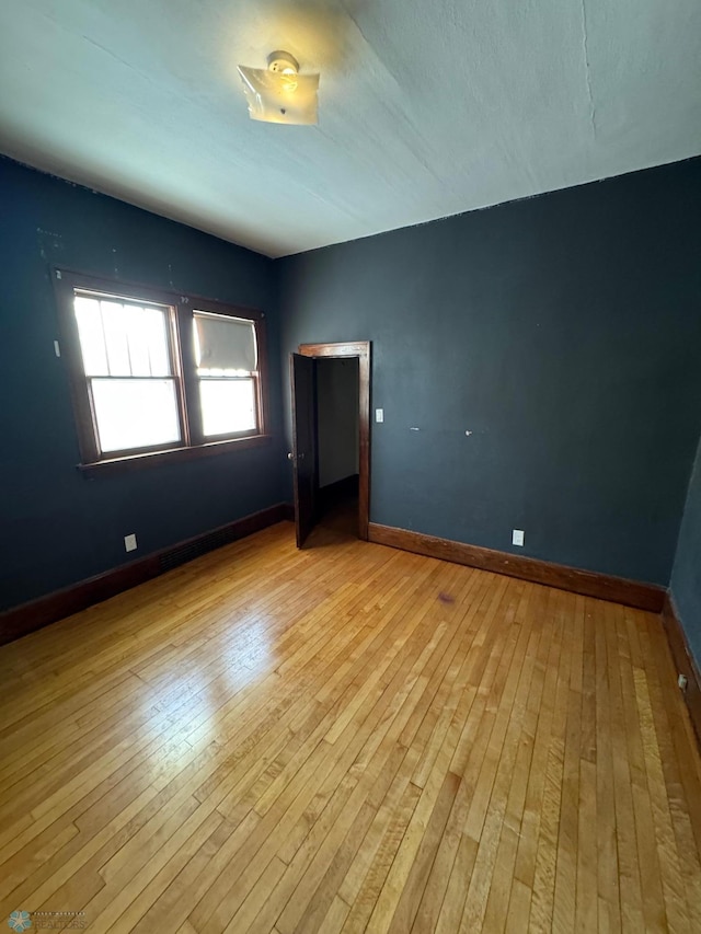 spare room featuring light hardwood / wood-style floors