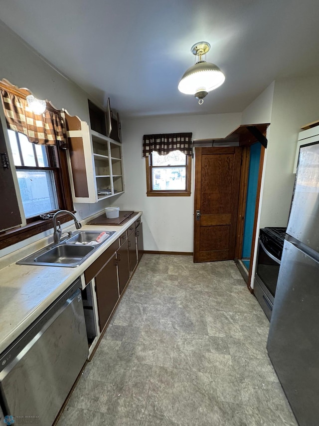 kitchen featuring stainless steel appliances, sink, and dark brown cabinetry