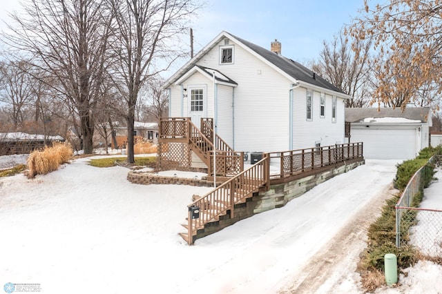 exterior space featuring stairway, fence, a chimney, and a garage