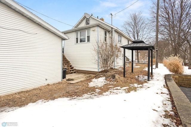 view of snowy exterior featuring a gazebo