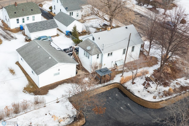 snowy aerial view with a residential view