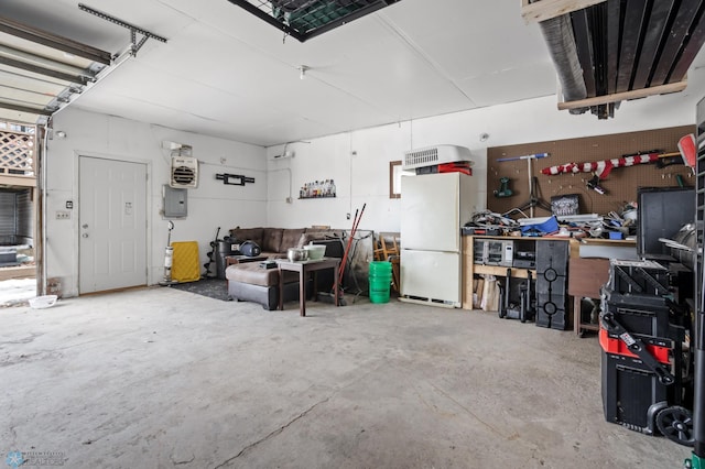 garage featuring freestanding refrigerator and electric panel