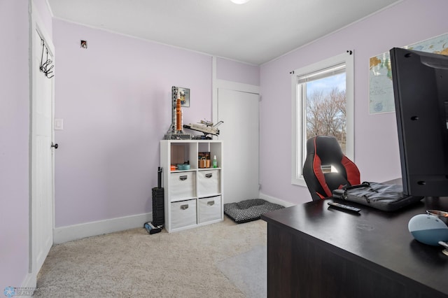 home office featuring baseboards and light colored carpet