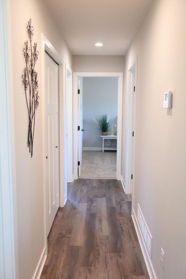 hall with dark hardwood / wood-style flooring