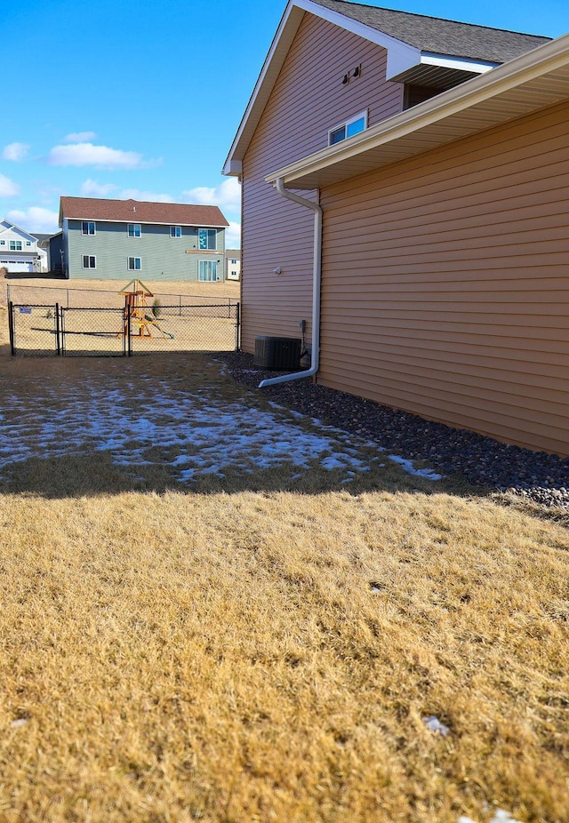 exterior space with cooling unit and a yard