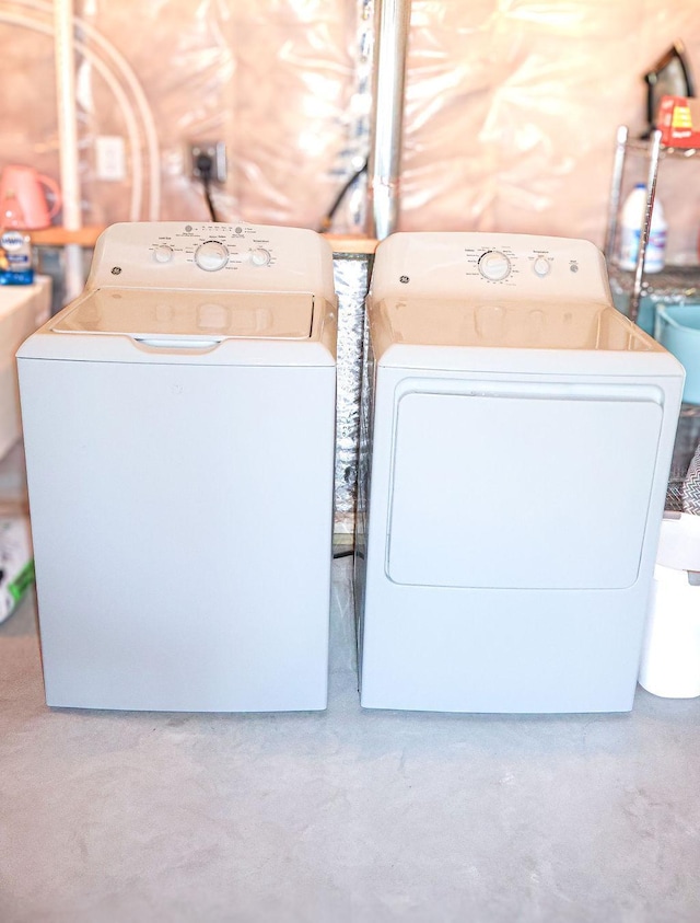 clothes washing area featuring separate washer and dryer