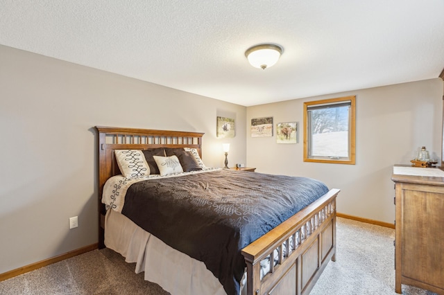 carpeted bedroom with baseboards and a textured ceiling