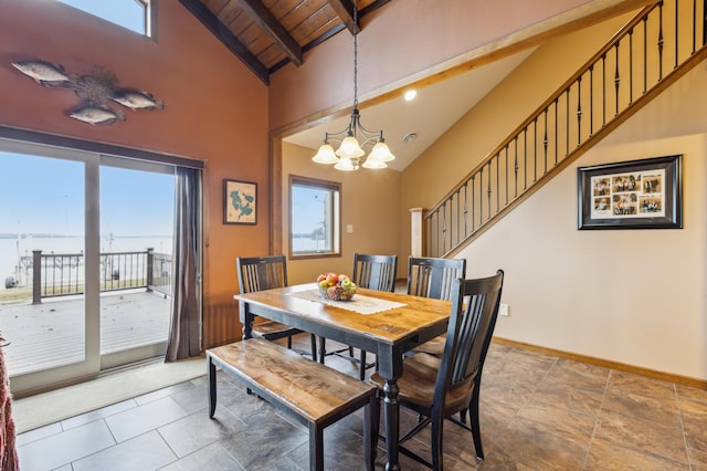 dining space featuring beamed ceiling, plenty of natural light, a notable chandelier, and baseboards