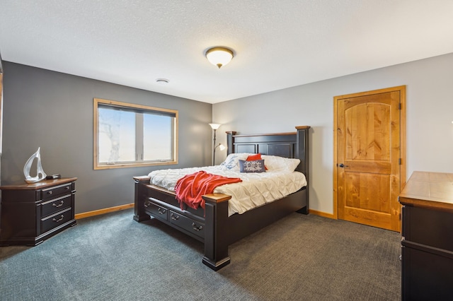 bedroom with baseboards, a textured ceiling, and dark carpet