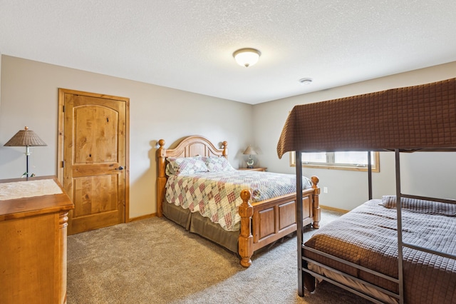 bedroom with baseboards, light carpet, and a textured ceiling