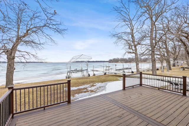 wooden deck featuring a water view and a boat dock