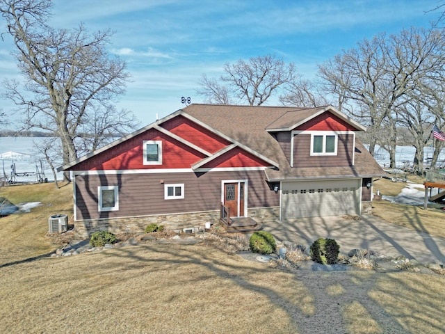 view of front of house featuring a front lawn, stone siding, concrete driveway, an attached garage, and central AC unit