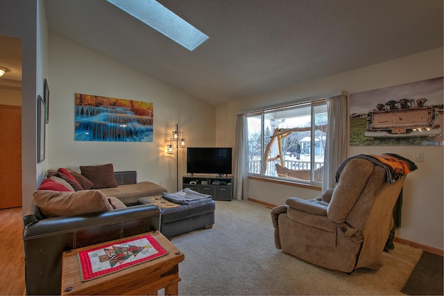 living room with carpet flooring and vaulted ceiling with skylight