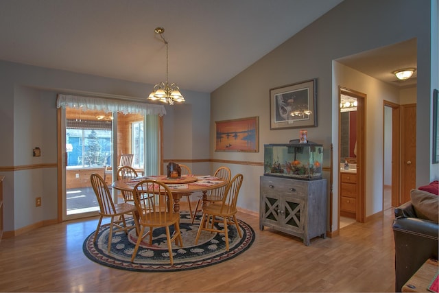 dining space featuring vaulted ceiling, a chandelier, and light hardwood / wood-style floors