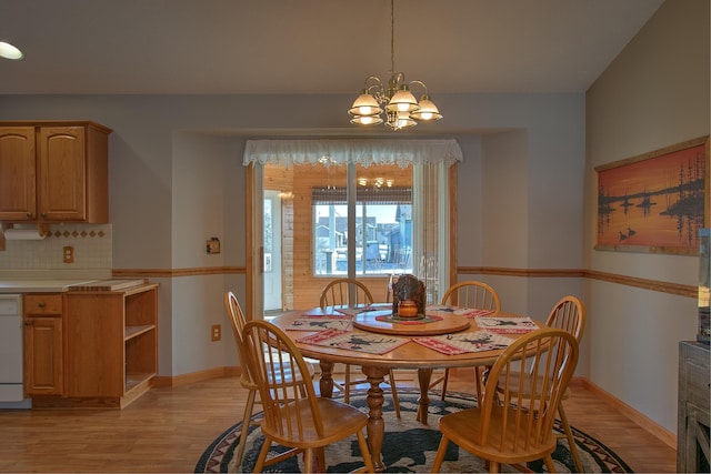 dining space featuring an inviting chandelier and light hardwood / wood-style flooring