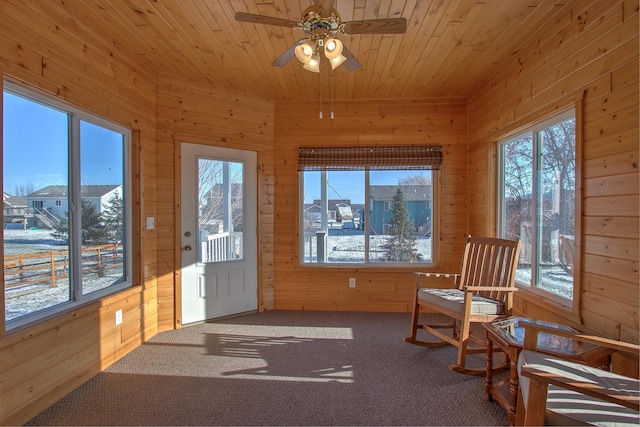 sunroom / solarium with wood ceiling, ceiling fan, and plenty of natural light