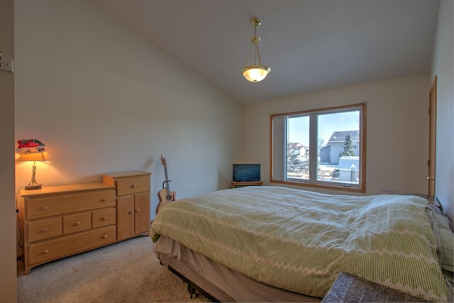 bedroom with lofted ceiling and light carpet