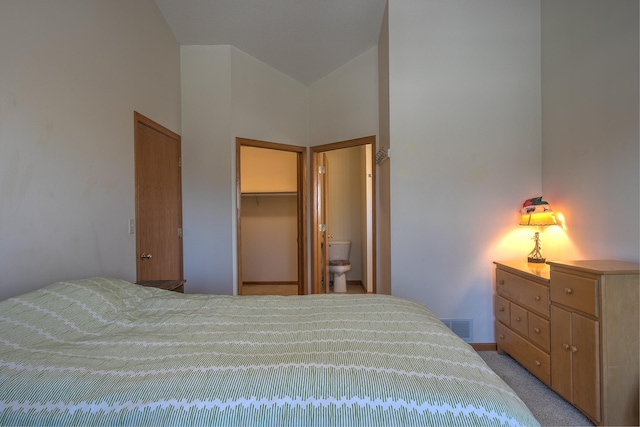 bedroom featuring light colored carpet, a spacious closet, and a closet