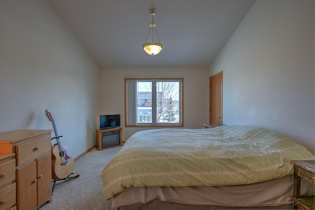 bedroom featuring lofted ceiling and light carpet