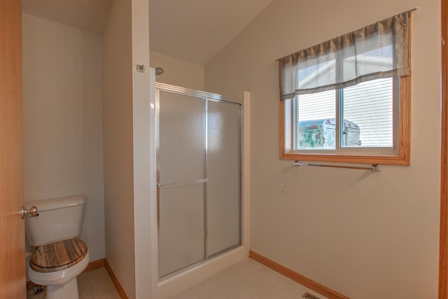 bathroom featuring toilet, an enclosed shower, and vaulted ceiling