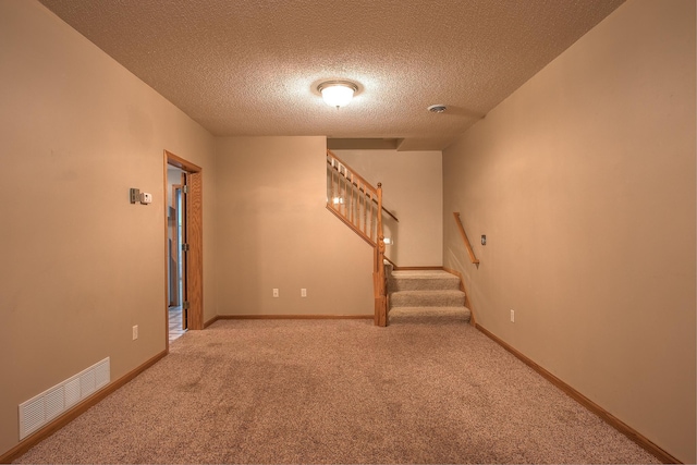 interior space featuring light carpet and a textured ceiling