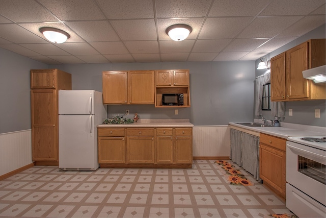 kitchen with sink, white appliances, and a paneled ceiling