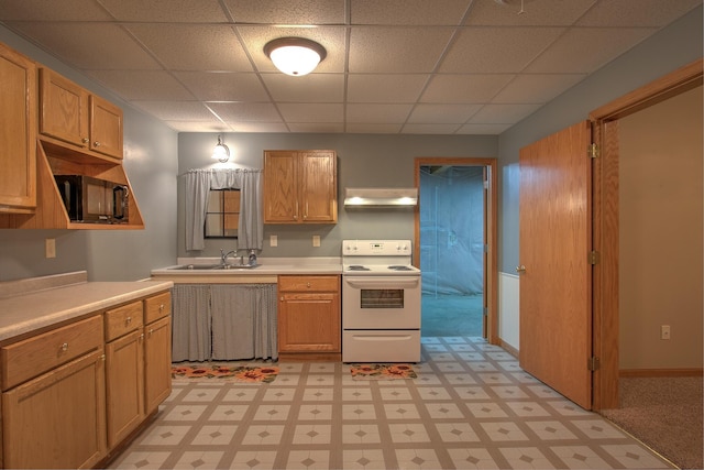 kitchen with electric stove, sink, hanging light fixtures, and a drop ceiling