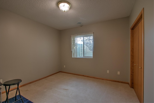 unfurnished bedroom featuring carpet floors and a textured ceiling