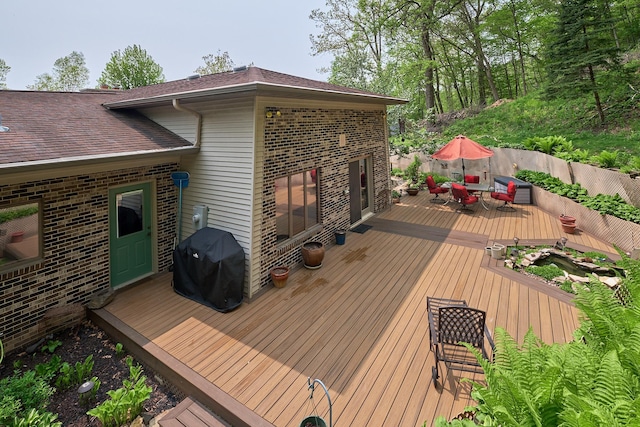 wooden deck featuring area for grilling