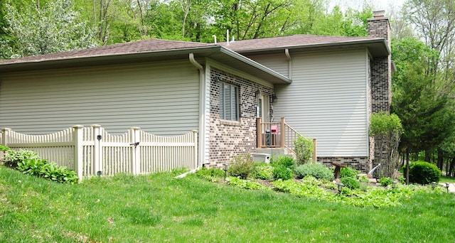 view of property exterior featuring a lawn