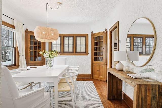 dining area featuring hardwood / wood-style floors and a textured ceiling