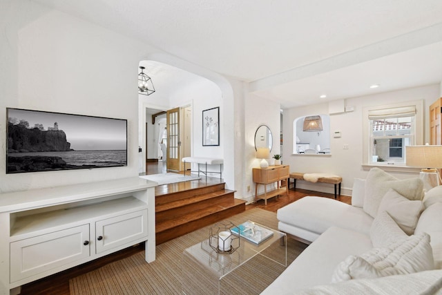 living room with a chandelier and light hardwood / wood-style floors